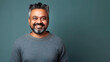 © Robert Kneschke - Indian man in 40s beaming, short hair, dark blue background