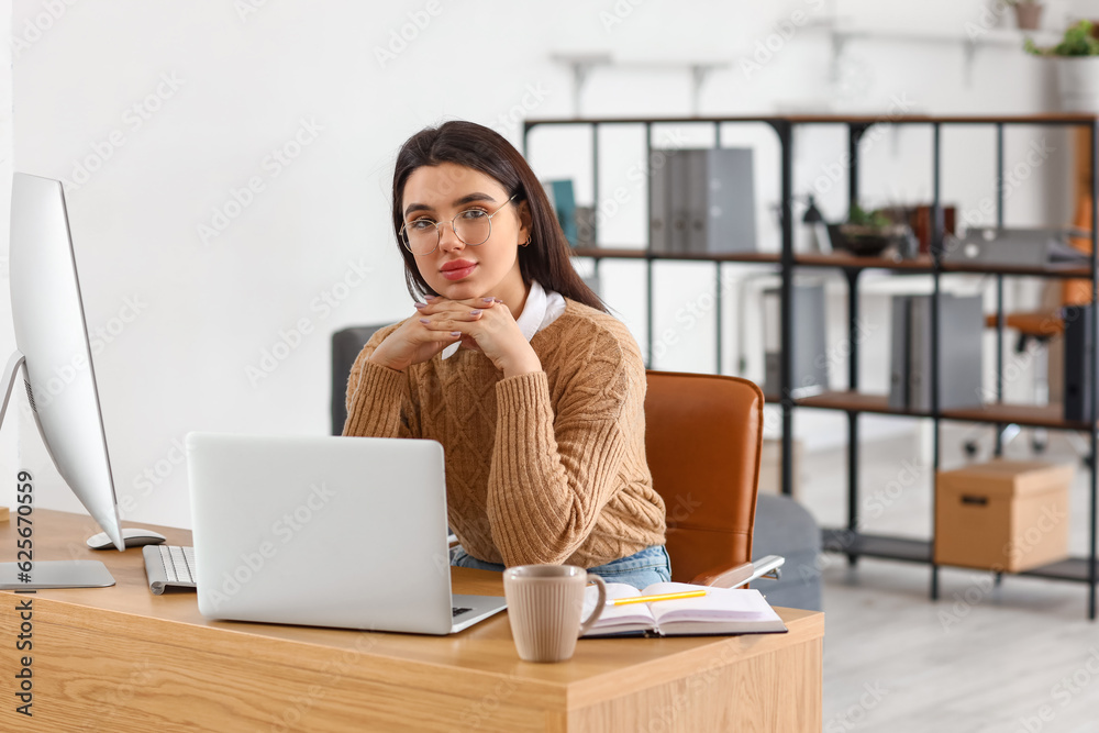 Young female programmer working in office