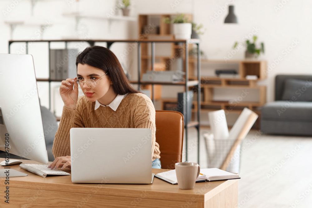 Young female programmer working in office