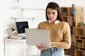 young female programmer with laptop in office