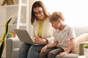 Sticker - Nanny with little boy watching cartoons at home