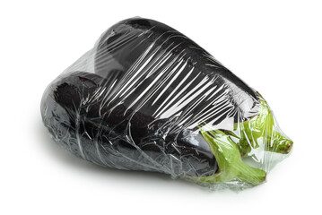 Wall Mural - Fresh eggplant in plastic food wrap on white background