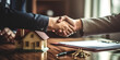 © Gabriela - Two hands of people closing a house sale, shaking hands, real estate concept