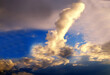 Funny cloud in the shape of phallus phallic symbol phallus in the sky in the evening in the light of sunset.