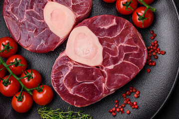 Wall Mural - Fresh raw beef steak with bone or ossobuco with salt, spices and herbs