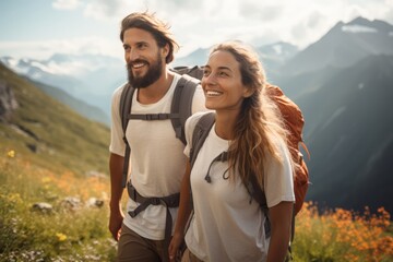 a couple young hiking in the mountains in summer with energetic expression