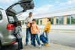 © Elena Medoks - Back to school. Dad escorts his children to school, father takes school bags out of the car. Parental care for children