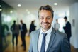 portrait of a handsome smiling white european american businessman boss in a suit standing in his modern business company office. his workers standing in the blurry background. Generative AI