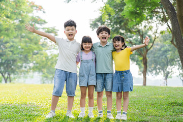 Wall Mural - group of cute asian kids having fun in the park