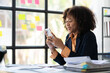 © ArLawKa - African american businesswoman working with laptop and financial documents meeting online in business office tax planning analysis financial report investment business plan