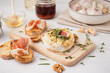 © Pixel-Shot - Wooden board with tasty baked Camembert cheese on grey background