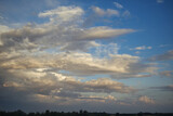 Fototapeta Tęcza - Beautiful blue sky with wispy white cumulus clouds