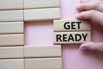 Wall Mural - get ready symbol. wooden blocks with words get ready. beautiful pink background. businessman hand. b