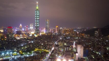 Wall Mural - Aerial timelapse of Downtown Taipei at night, the vibrant capital city of Taiwan, with 101 Tower standing out among modern skyscrapers in XinYi Commercial District and city lights dazzling in the dark