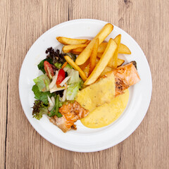 Canvas Print - Salmon steak with fries, salad and hollandaise sauce