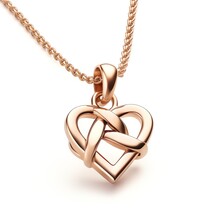 A Gold Heart Necklace With A Knot