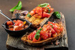 Fresh homemade crispy Italian Bruschetta topped with tomato, Traditional italian appetizer or snack, Food recipe background. Close up