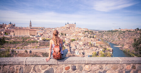 Wall Mural - woman travelling in europa- panoramic view of toledo city in spain