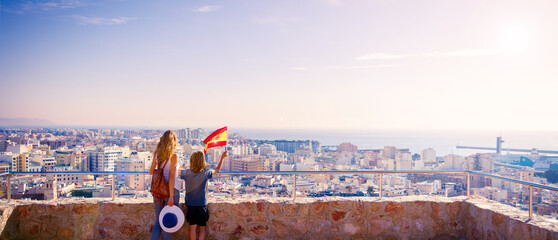 Wall Mural - Mother and son holding spanish flag- Travel in Spain- ruban skyline