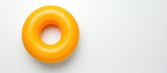 Poster - Photo of a yellow donut on a white table with plenty of space for text or design with copy space