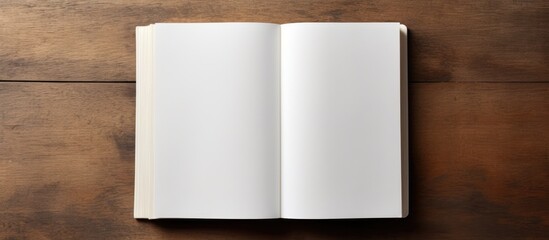 Photo of an open book on a wooden table with plenty of space for writing or doodling with copy space