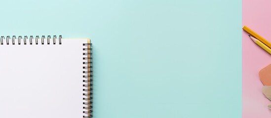 Poster - Photo of a notebook and pencil on a pastel blue and pink background with plenty of copy space with copy space
