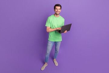 Aufkleber - Full body photo of young workaholic guy wear green t-shirt jeans with modern apple netbook gadget device isolated on purple background