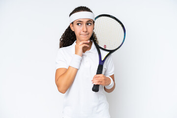 Wall Mural - Young tennis player woman isolated on white background having doubts and thinking