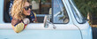 © simona - Banner image of young pretty woman traveler smile outside the window of her blue classic van vehicle.  Traveler female people concept and tourism. One middle age lady enjoy vacation and transport