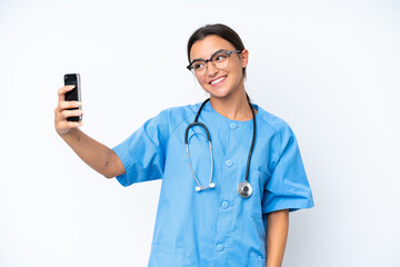 Poster - Young nurse woman isolated on white background making a selfie