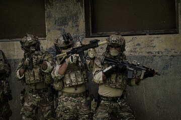 United States Army ranger during the military operation. Professional marine soldiers training with weapon on a military range.