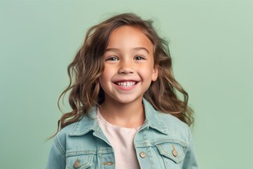 Sticker - Portrait of a smiling little girl with long curly hair on a green background