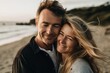 Couple in their 40s smiling happy on a sea shore,embracing