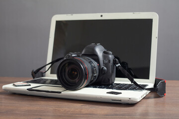 Modern DSLR camera and laptop computer.