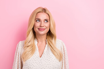 Poster - Portrait of good mood stunning woman with curly hairdo wear white dress look at proposition empty space isolated on pink color background