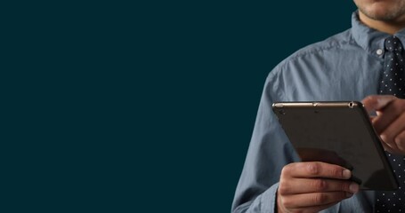 Poster - Animation of midsection of caucasian man surfing on digital tablet against black background