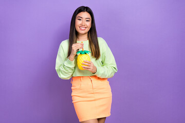 Wall Mural - Portrait of pleasant satisfied cute girl wear stylish pullover hold pineapple cup drink cocktail isolated on violet color background