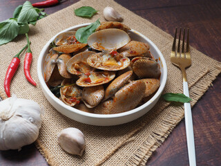 Stir fried Clams with roasted chili paste - Thai food at close up view on wood table 