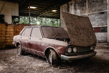 Old Car With Dust And Dirt Stuck In An Abandoned Building. Vintage Car