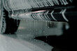 A close-up of car foam on the door sills of a black luxury car in a carwash box 