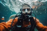 Fototapeta Do akwarium - Scuba diver looking at the camera while diving in the ocean.