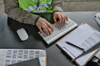 © AnnaStills - High angle view of worker of warehouse working online on computer at her workplace