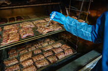 Grilled Barbecue Pork Ribs In A Smoker At The Factory. The Concept Of A Delicious Snack For A Picnic Or A Country House