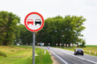 © Sergey Chayko - The overtaking sign is prohibited on the background of a highway with passing cars