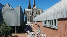 Aerial View Of Tourist People At Heinrich Boll Platz With View Of Ludwig Museum And Dom Cathedral In Cologne, Germany, Slow Motion
