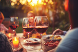 Fototapeta Panele - Happy friends and family having barbecue party in the backyard. Young people celebrating at dinner drinking red wine at sunset - Focus on wine glass 