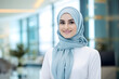 © AGSTRONAUT - muslim receptionist smile in blue and white hijab outfit