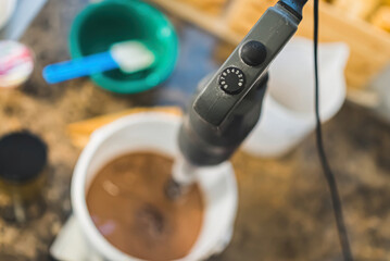 Top view closeup shot of professional blender mixing chocolate ice cream in big bucket. Handmade icecream concept. . High quality photo