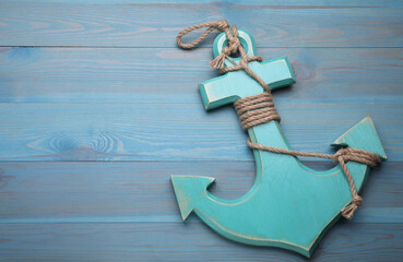 Sticker - Anchor with hemp rope on light blue wooden table, top view. Space for text