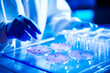 © MVProductions - Closeup of lab technician examining a petri dish containing a precision sample, representing advanced biotechnology research